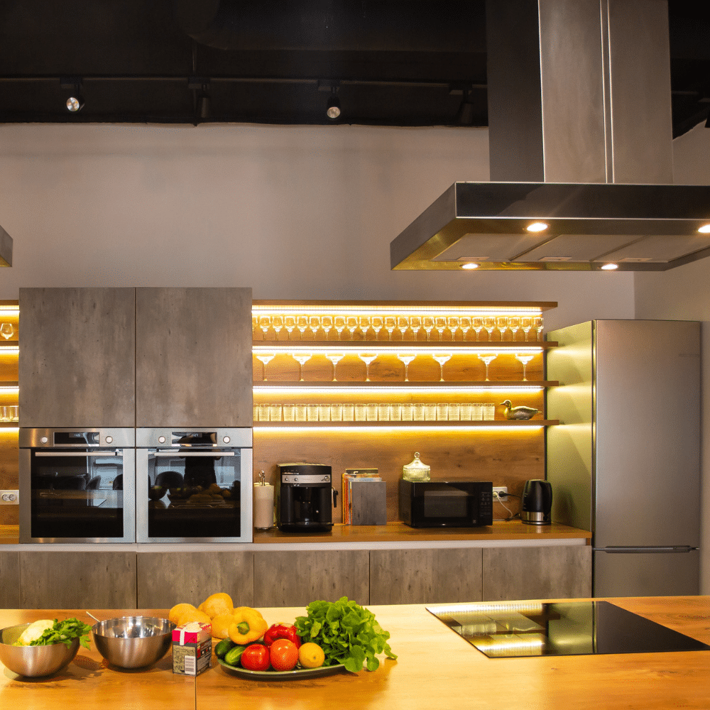 Industry clarity for electrical compliance - modern kitchen with double ovens, microwave, induction hob and glassware lighting