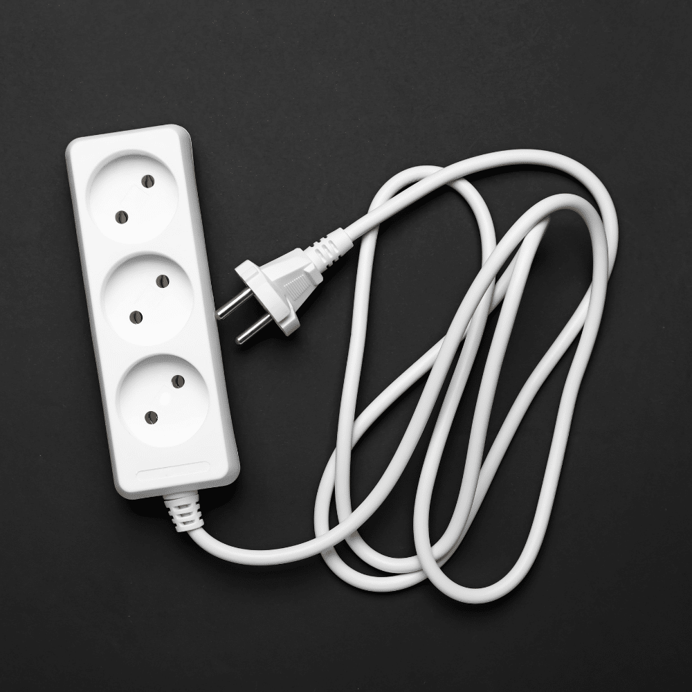 Industry clarity for electrical compliance - white 3-way Schuko extension lead on black background showing non-compliant type