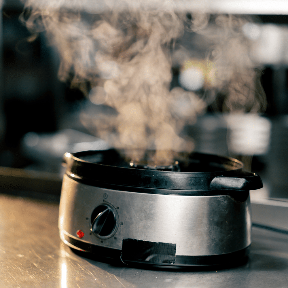 Industry clarity for electrical compliance - steaming faulty slow cooker with black tape repair hazard