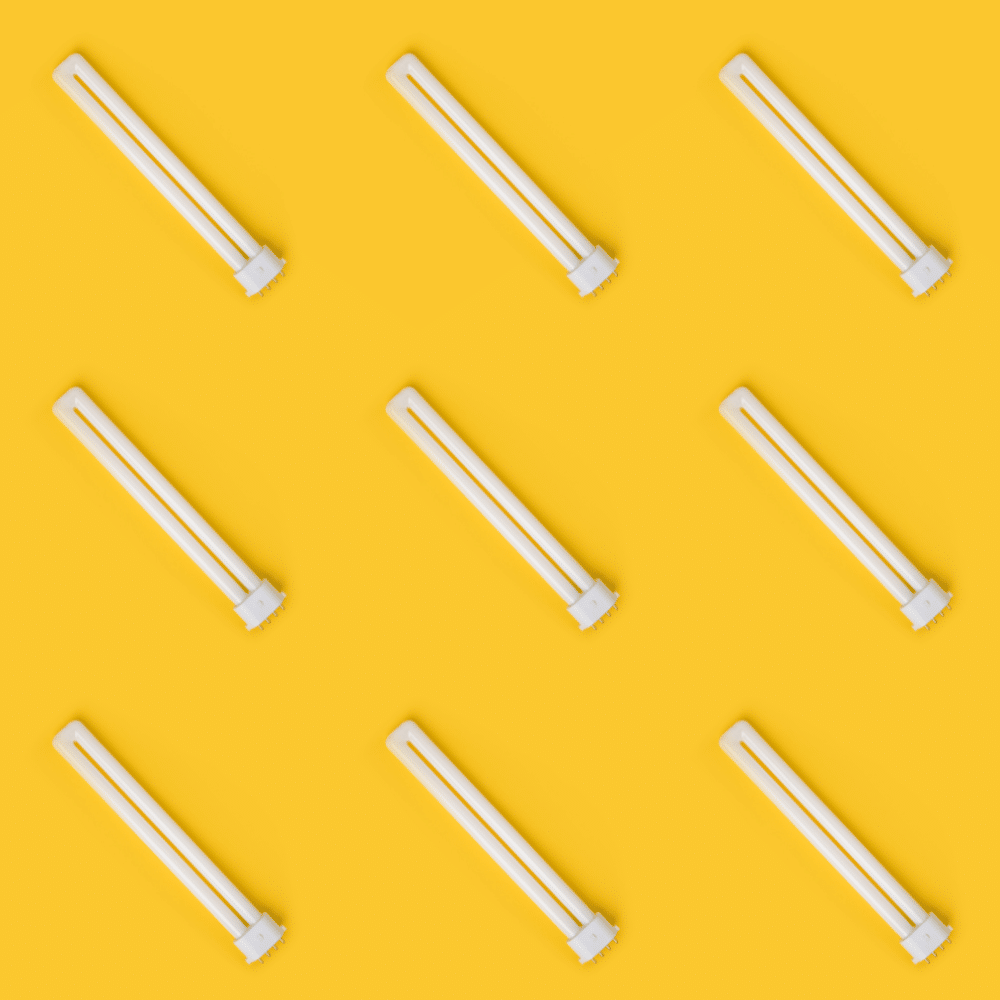 Industry clarity for electrical compliance - nine CFL U-shaped lamps on bright yellow background pattern