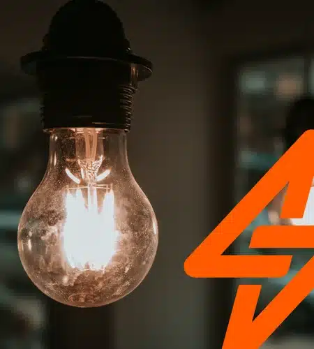Illuminated light bulb with orange lightning icon representing Unsafe electrical products awareness